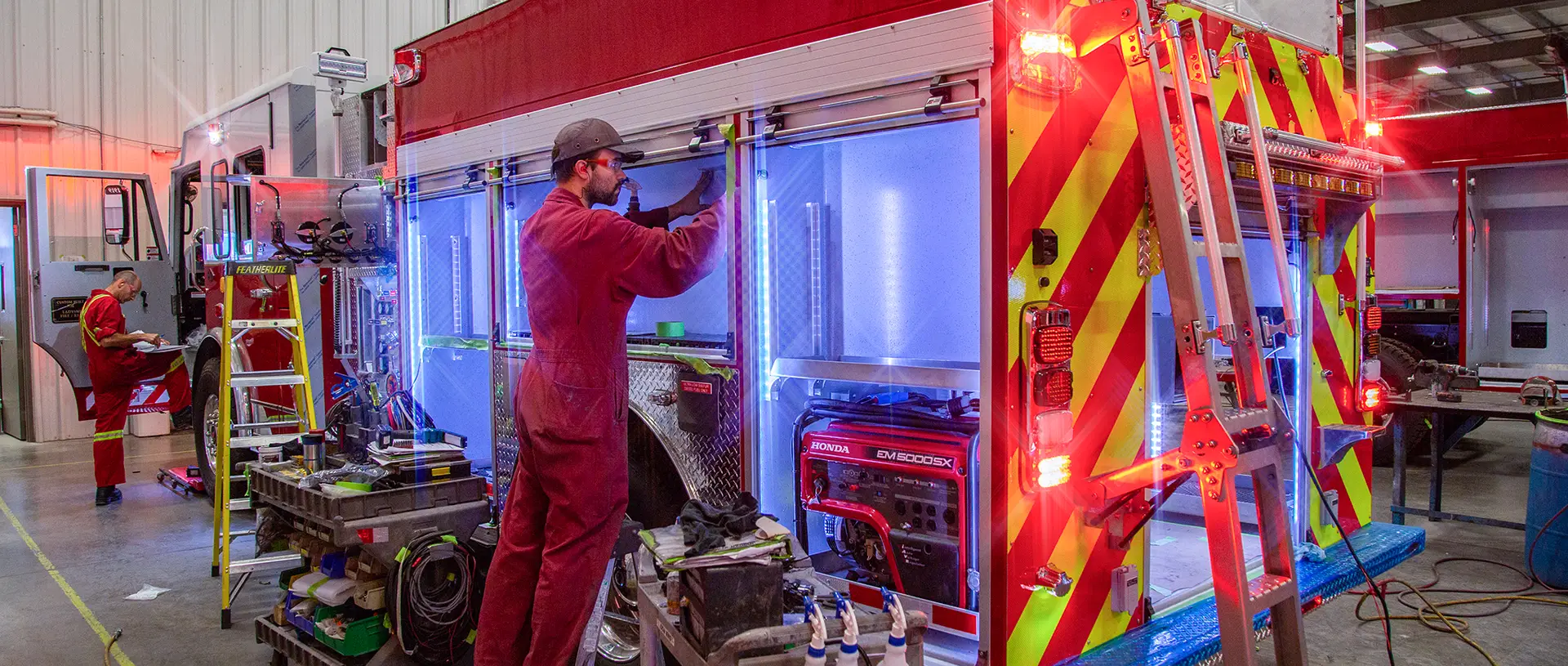 Technician Working on Fire Truck Compartment Electrical Lighting